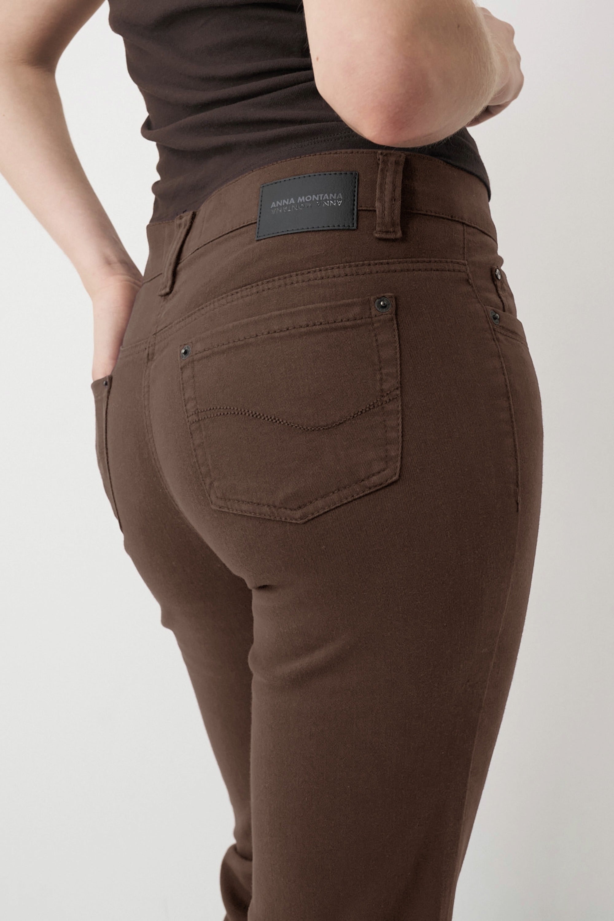 Braune Damenjeans mit schmalem Bein und mittlerer Leibhöhe.